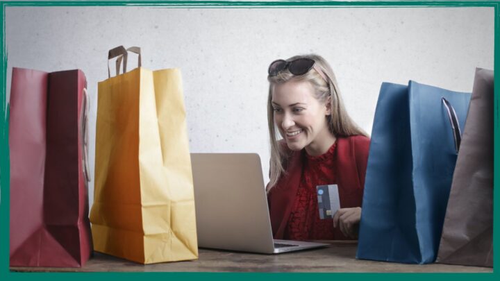 woman surrounded by gift bags shops online